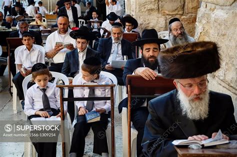 Orthodox Jewish People Praying At A Synagogue By The Western Wall Wall
