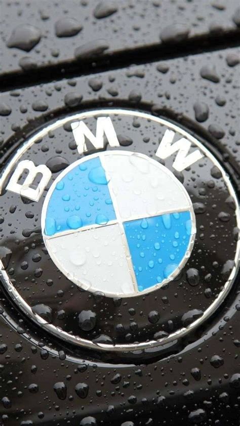 The Bmw Logo On A Black Car With Raindrops Wallpaper Download 1080x1920