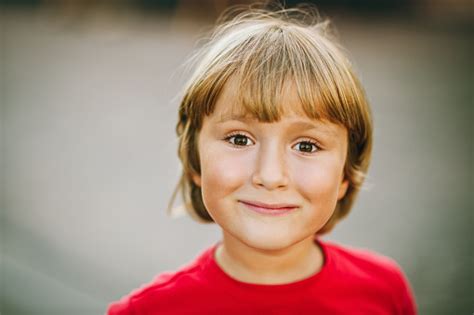 Outdoor Close Up Portrait Of Adorable 6 Year Old Kid Boy Candid Facial