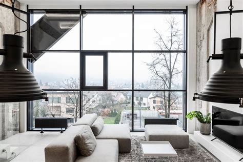 A Living Room Filled With Furniture And Large Windows