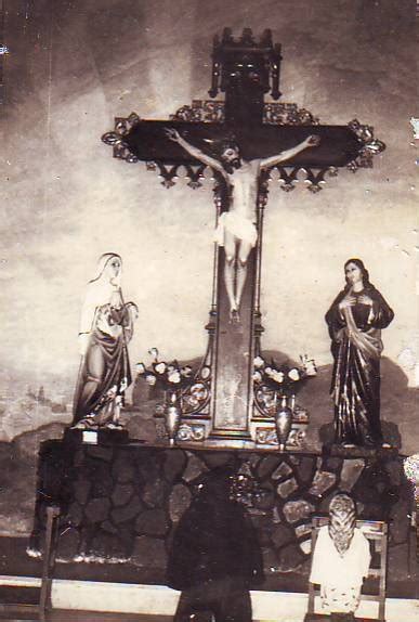An Old Black And White Photo Of People In Front Of A Crucifix