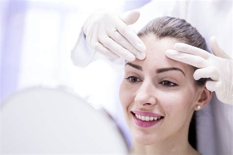Doctor Examining Young Womans Forehead Hancock Regional Hospital