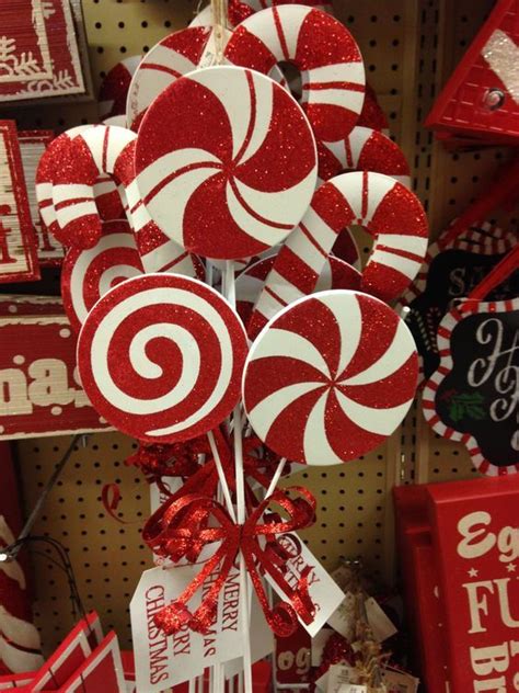 Some Lollipops Are On Display For Sale In A Store With Red And White Decorations