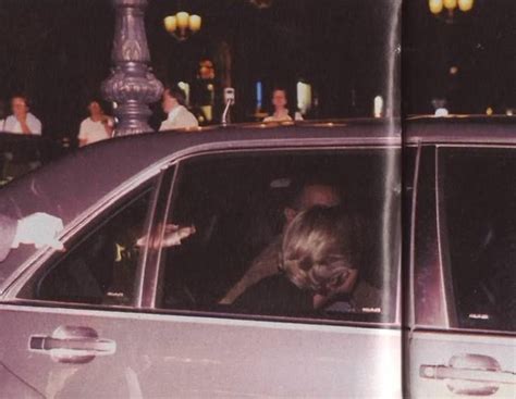 A Woman Sitting In The Passenger Seat Of A Car Talking On Her Cell