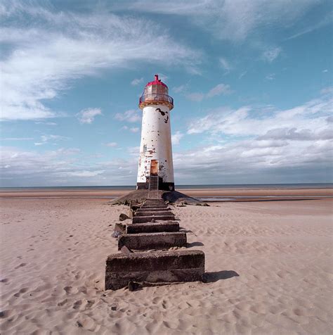 Red and white lighthouse norfolk. An Old White Lighthouse With A Red Roof On A Sandy Beach ...