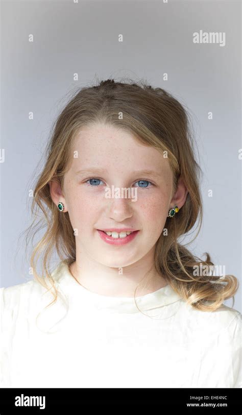 Young 10 Year Old Girl Smiling Face To Camera In White Dress Stock