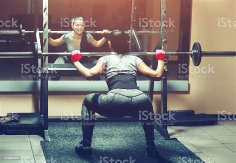 Slim Girl Bodybuilder Lifting Heavy Barbell Standing In Front Of The