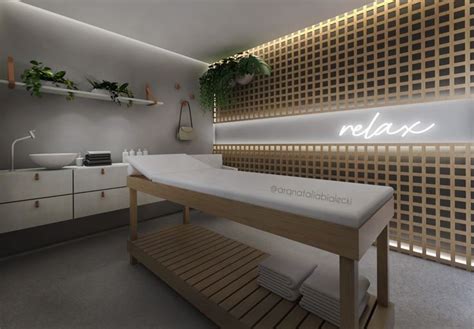 A Spa Room With Wooden Shelves And Plants On The Wall Along With An Illuminated Sign That Reads