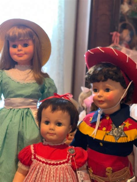 Three Dolls Are Standing Next To Each Other