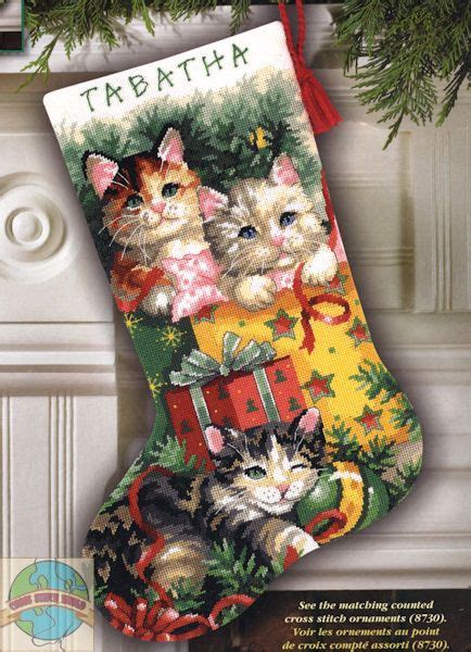 a cross stitch christmas stocking with kittens on it