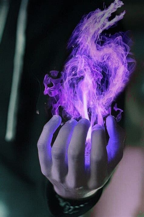 A Person Holding Up A Purple Substance In Their Hand With The Light On It