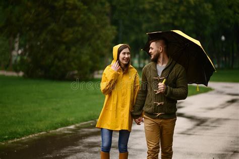 Love Couple With Umbrellas Walks In Park Back View Stock Photo Image
