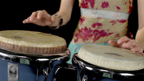 female percussion drummer performing with bongos 2 stock footage videohive