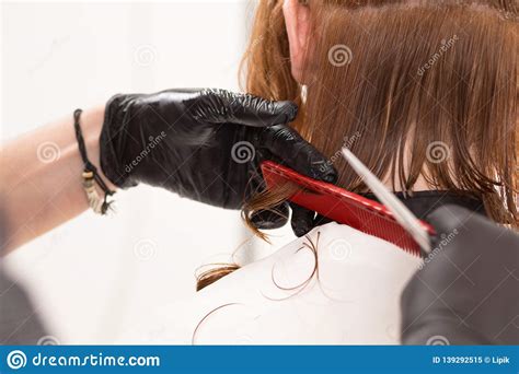 Closeup Of Barber Cutting Customer S Hair With Scissors And Comb Stock