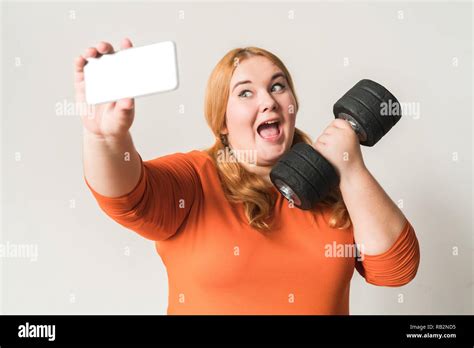 Chubby Woman Sport At Home Standing Isolated On White Taking Selfie Photos With Dumbbell Excited
