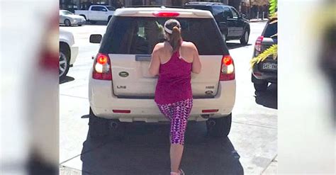 stubborn woman claims empty parking spot by standing in it then a driver tries to steal it
