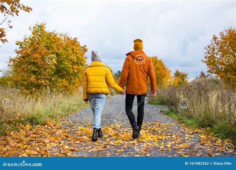 Back View Of Young Couple Walking In Autumn Park Stock Photo Image Of