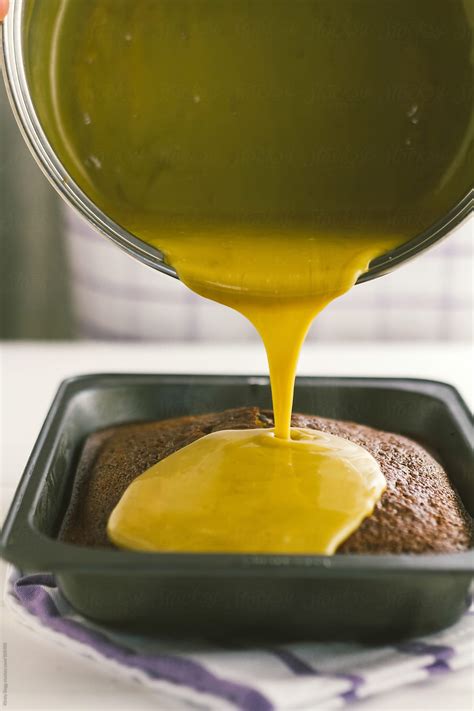 Toffee Sauce Being Poured Onto Cake By Stocksy Contributor Kirsty Begg Stocksy