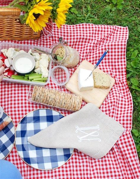 A Picnic Is Set Out On The Grass With Cheese Bread And Other Food Items