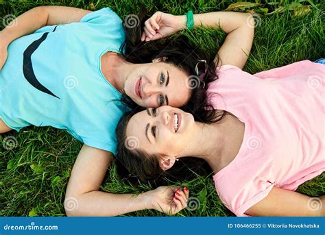 Two Happy Young Girls Lie On The Grass Stock Image Image Of Care