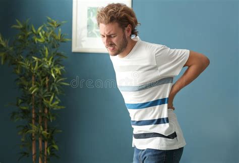 Young Man Suffering From Back Pain At Home Stock Image Image Of