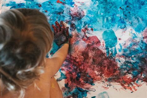 Toddler Painting On Canvas From Above Del Colaborador De Stocksy