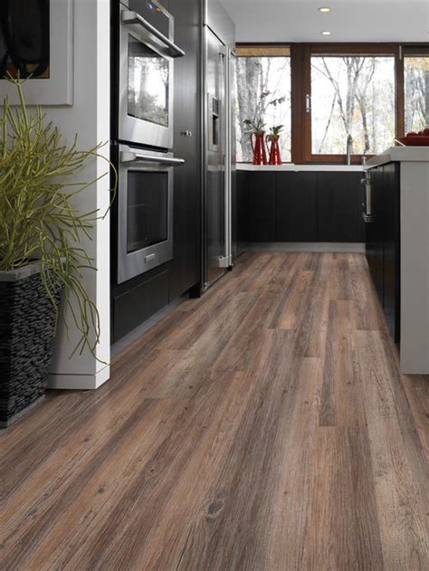 Laminate wood flooring is an affordable and durable kitchen flooring idea. Best Kitchen with Vinyl Floors Design Ideas & Remodel Pictures | Houzz