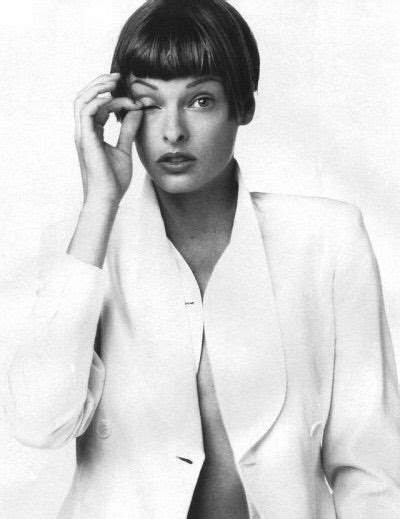 A Black And White Photo Of A Woman With Short Hair Wearing A Blazer Jacket