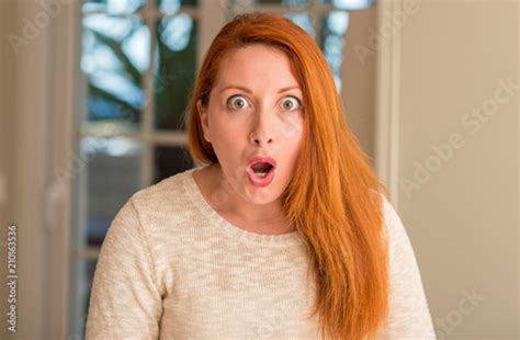 Redhead Woman At Home Scared In Shock With A Surprise Face Afraid And Excited With Fear