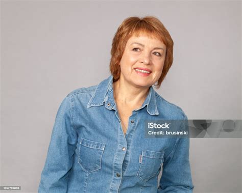Close Up Studio Portrait Of Attractive 60 Year Old Woman With Short Red