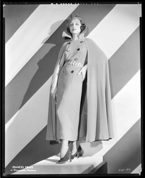 An Old Fashion Photo Of A Woman Wearing A Cape