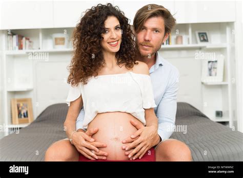 Man Touching The Belly Of His Pregnant Wife Stock Photo Alamy