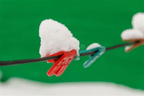 clothespins on clothesline covered with snow winter scene housework concept stock image