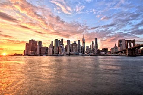 New York City Lower Manhattan With Brooklyn Bridge At Sunset Stock