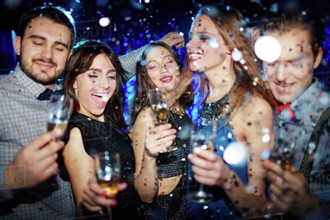 Group Of Friends Toasting With Champagne At Party In Night Club Stock