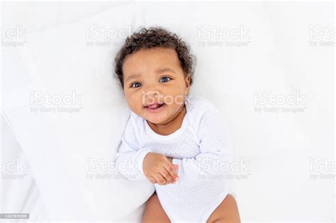 Smiling Little African American Baby In A Crib Portrait Stock Photo