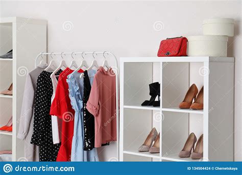 Wardrobe Shelves With Different Stylish Shoes And Clothes Indoors Idea