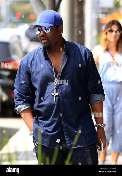 Singer Songwriter Johnny Gill Seen Paying A Parking Meter While Out And