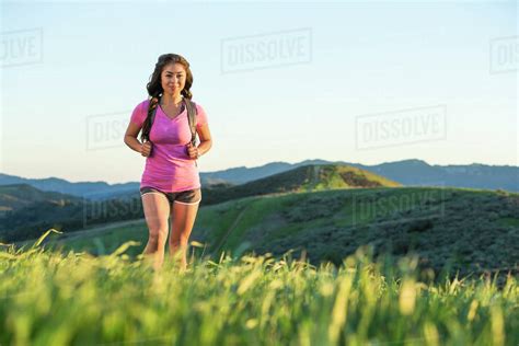 Asian Woman Hiking On Hill Stock Photo Dissolve