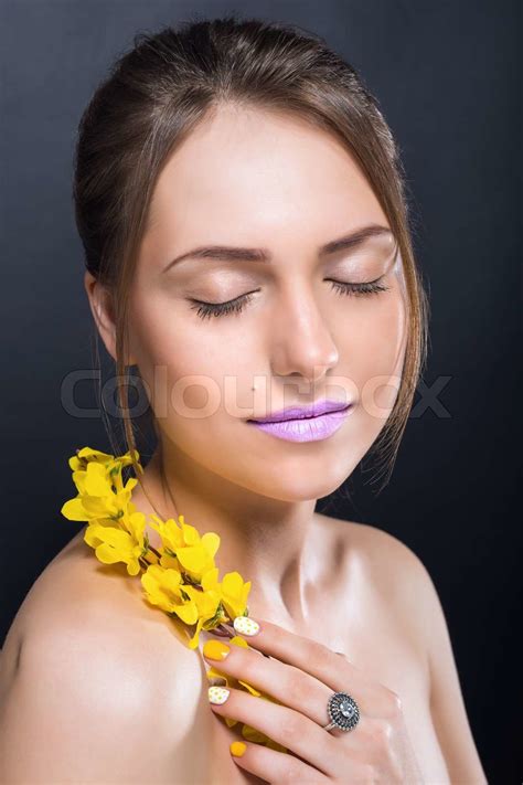 Сlose Portrait Of Beautiful Naked Girl With Bright Makeup And Flowers