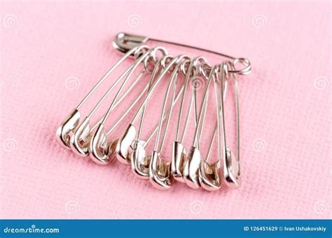 Set Of Safety Pins Lying On Pink Paper Stock Image Image Of Pink