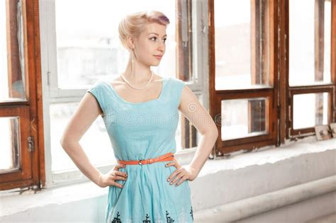 Big Breasted Blonde In A Blue Dress By The Window Stock Image Image