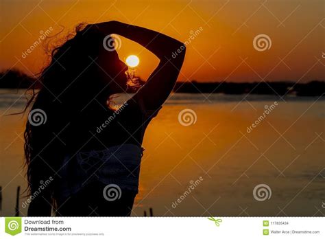 Hispanic Brunette Model Enjoying An Early Morning Sunrise Stock Photo
