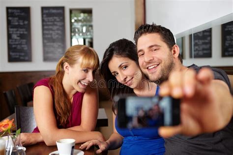 Group Takes Cell Phone Photos In The Cafe Stock Photo Image Of