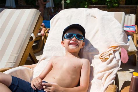 Cute Little Boy Sunbathing At Ocean Beach Stock Photo Image Of Summer