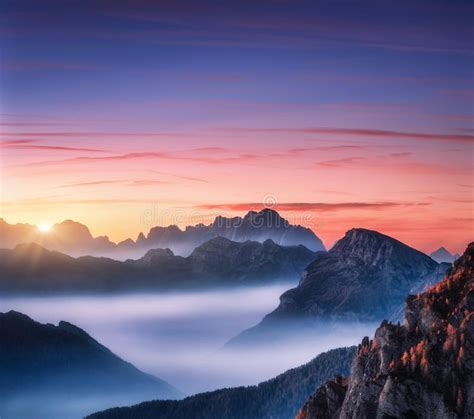 Mountains In Fog At Beautiful Sunset In Autumn Stock Photo