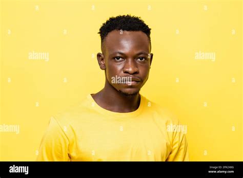 Close Up Portrait Of Young African Man Face On Isolated Yellow Studio