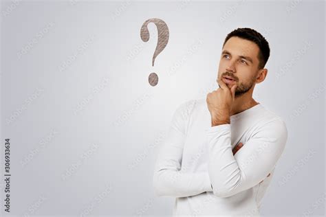 Portrait Of Doubtful Bearded Man In Casual White Shirt Asking Questions