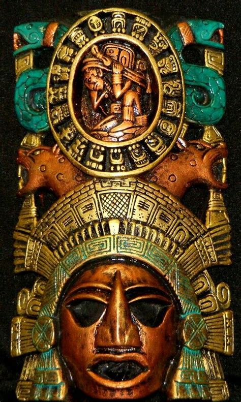An Ancient Mask Is Displayed On A Black Surface With Gold And Green Accents Including The Head