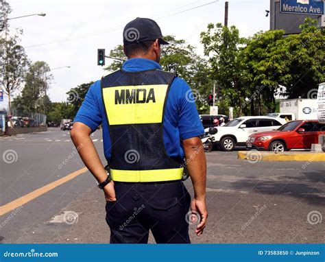A Traffic Enforcer Stands At A Road Intersection Editorial Image